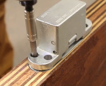 SOSS hinge being installed on door.