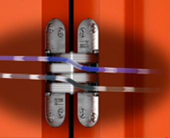SOSS invisible power transfer hinges with concealed wiring shown between an orange door and frame.