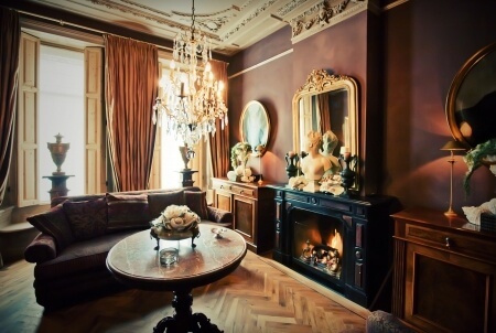 Fancy victorian space with fireplace and chandelier