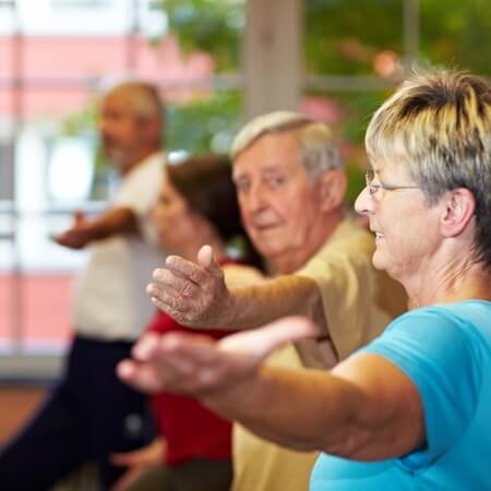 group of seniors stretching arms