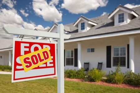 home with sign showing sold label