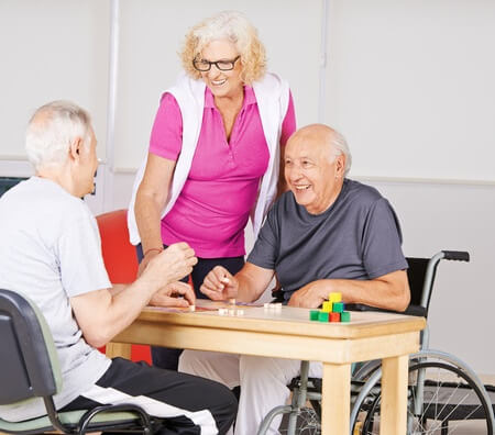 three aged caucasians playing board game