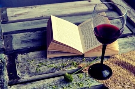 Open Book next to Wine Glass