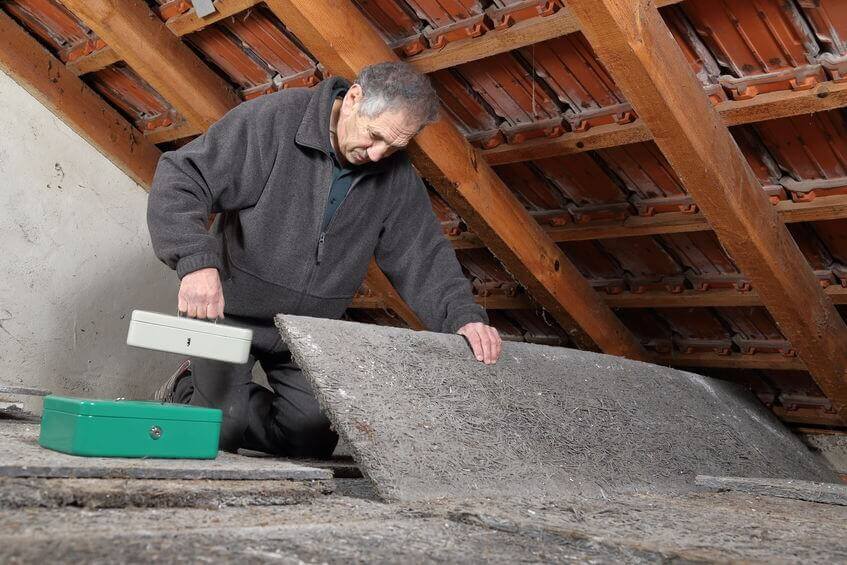 Man Hiding Boxes in Attic